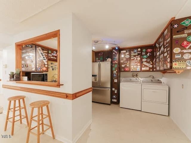 64 Robin Rd, Semora, NC 27343 - laundry area featuring washing machine and clothes dryer and baseboards