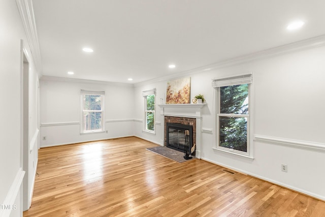 212 Heidinger Dr, Cary, NC 27511 - unfurnished living room featuring crown molding, light wood finished floors, a fireplace, and recessed lighting