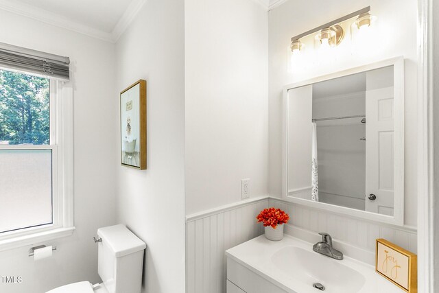 212 Heidinger Dr, Cary, NC 27511 - bathroom featuring crown molding, vanity, and wainscoting