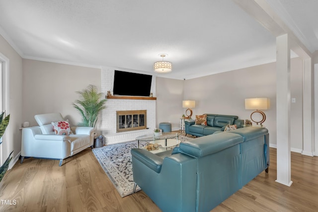 2003 Ryerson Dr, Garner, NC 27529 - living room with wood finished floors, ornamental molding, and a brick fireplace