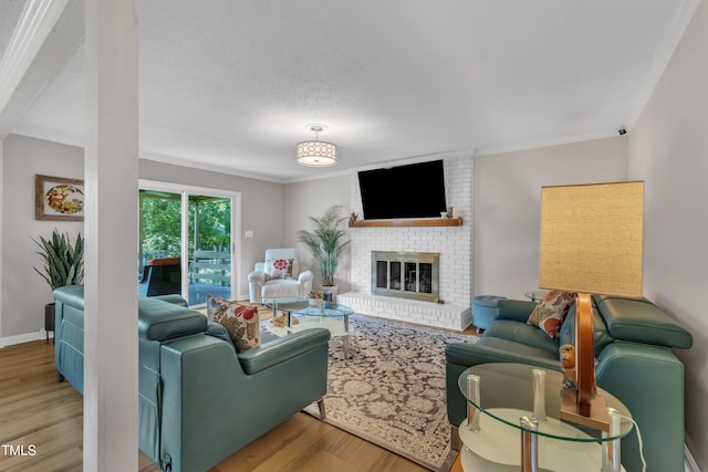 2003 Ryerson Dr, Garner, NC 27529 - living area featuring wood finished floors, ornamental molding, and a fireplace