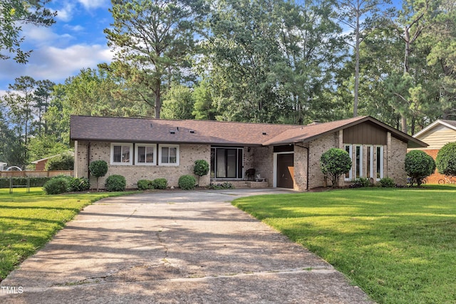 2003 Ryerson Dr, Garner, NC 27529 - view of front facade with brick siding, concrete driveway, a garage, and roof with shingles