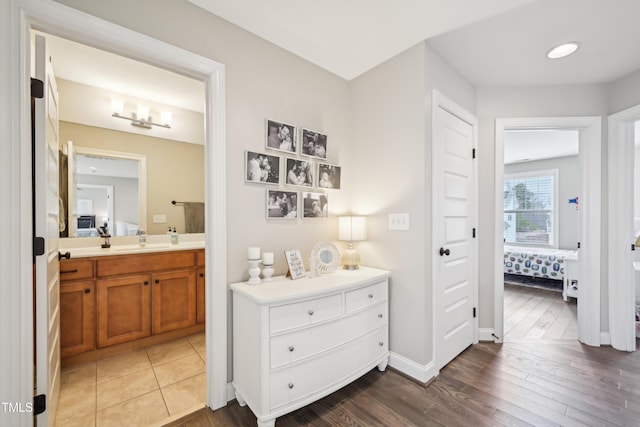 1985 Firenza Dr, Apex, NC 27502 - corridor featuring a sink and wood finished floors