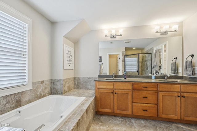 1985 Firenza Dr, Apex, NC 27502 - bathroom with double vanity, a shower stall, healthy amount of natural light, and a bath
