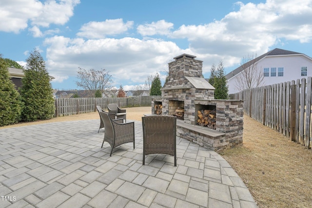 1985 Firenza Dr, Apex, NC 27502 - fenced backyard featuring an outdoor stone fireplace and a patio area