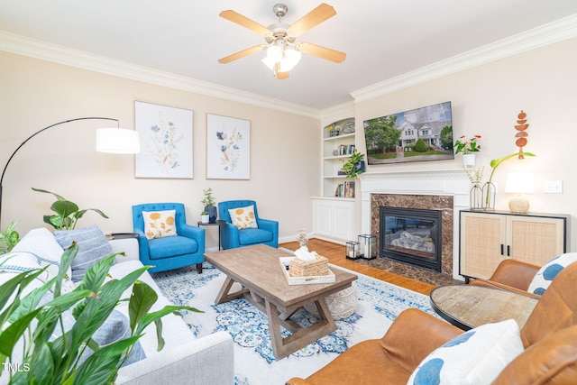 10906 Flower Bed Ct, Raleigh, NC 27614 - living room featuring crown molding, wood finished floors, a premium fireplace, a ceiling fan, and built in features