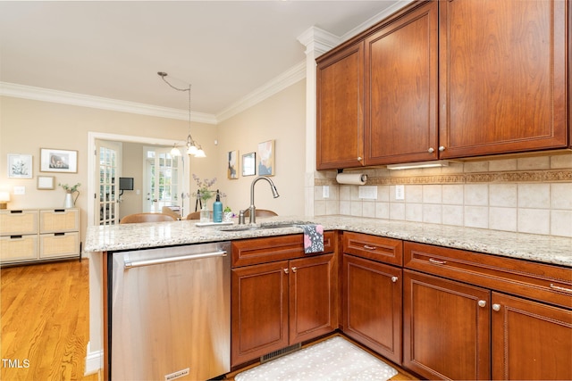 10906 Flower Bed Ct, Raleigh, NC 27614 - kitchen featuring dishwasher, a peninsula, ornamental molding, light stone counters, and brown cabinetry