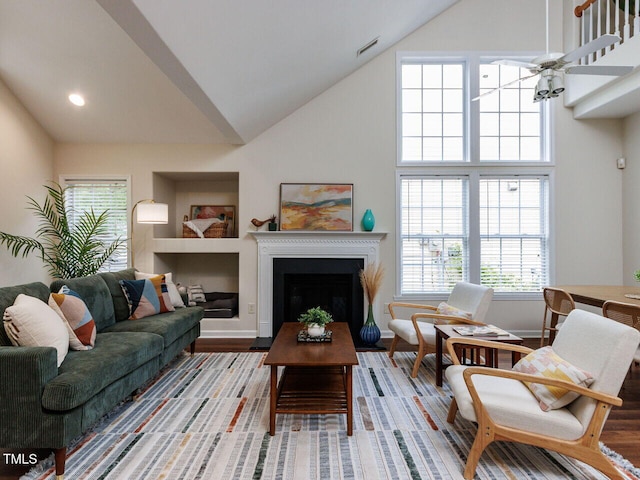 1103 Mallory Ln, Durham, NC 27713 - living room with high vaulted ceiling, plenty of natural light, a fireplace, light wood finished floors, and recessed lighting