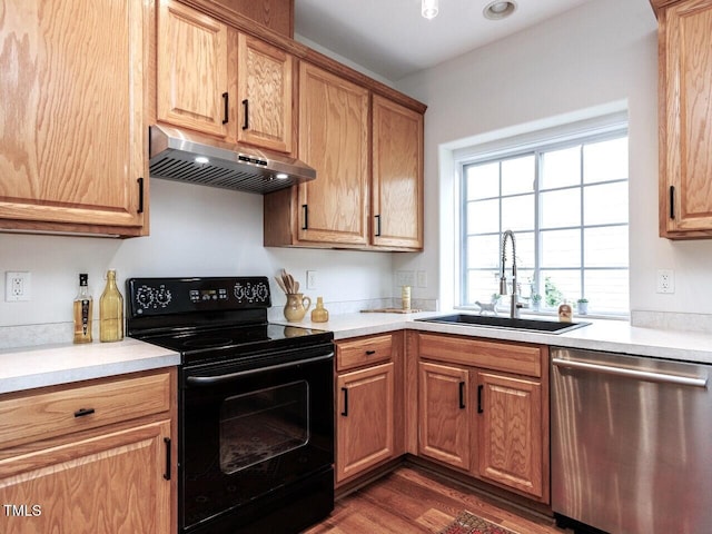 1103 Mallory Ln, Durham, NC 27713 - kitchen with dishwasher, black range with electric cooktop, under cabinet range hood, dark wood-style floors, and light countertops