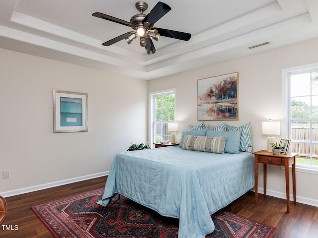 1103 Mallory Ln, Durham, NC 27713 - bedroom featuring a raised ceiling, wood finished floors, and a ceiling fan