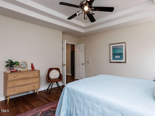 1103 Mallory Ln, Durham, NC 27713 - bedroom with dark wood-style flooring, a raised ceiling, and ceiling fan