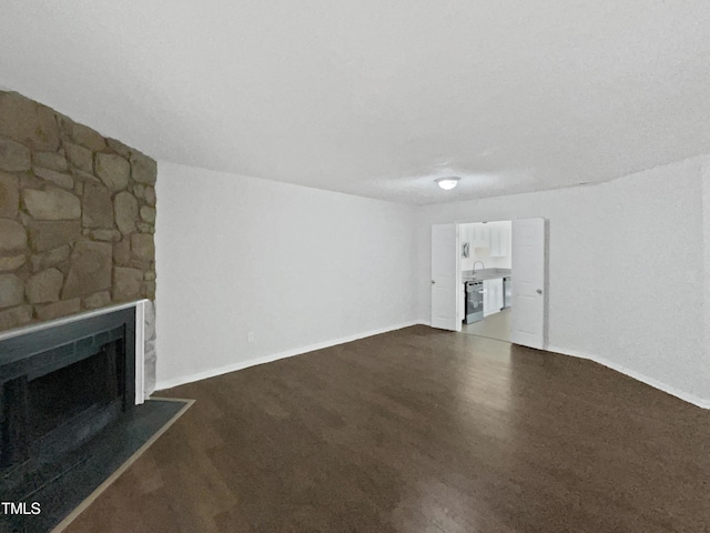 104 Mossbark Ln, Chapel Hill, NC 27514 - unfurnished living room with dark wood-type flooring and a fireplace