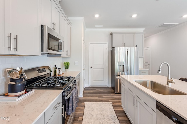 1149 Weavers Trace Dr, Zebulon, NC 27597 - kitchen featuring stainless steel appliances, dark wood finished floors, crown molding, light stone counters, and tasteful backsplash