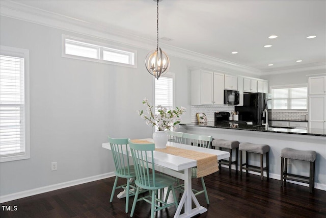 979 Branch Line Ln, Apex, NC 27502 - dining room with crown molding, a chandelier, dark wood-style flooring, and recessed lighting