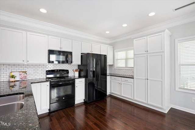 979 Branch Line Ln, Apex, NC 27502 - kitchen with black appliances, dark wood-style floors, white cabinets, dark stone countertops, and backsplash