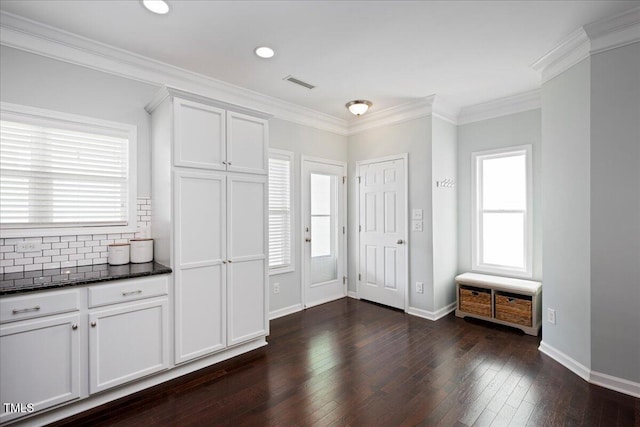 979 Branch Line Ln, Apex, NC 27502 - kitchen featuring dark wood-style floors, healthy amount of natural light, tasteful backsplash, white cabinetry, and crown molding