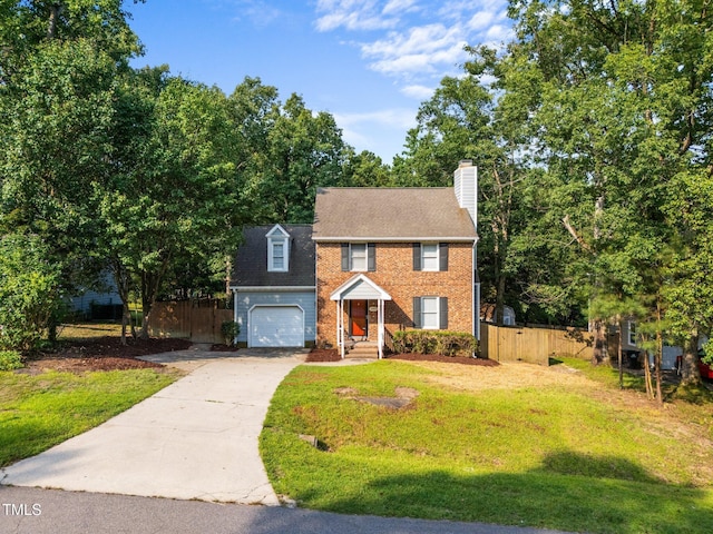 2205 Bufflehead Rd, Raleigh, NC 27616 - view of front of house featuring driveway, a chimney, and brick siding