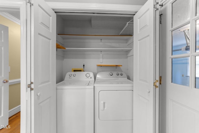 2205 Bufflehead Rd, Raleigh, NC 27616 - washroom featuring washing machine and clothes dryer, crown molding, and wood finished floors
