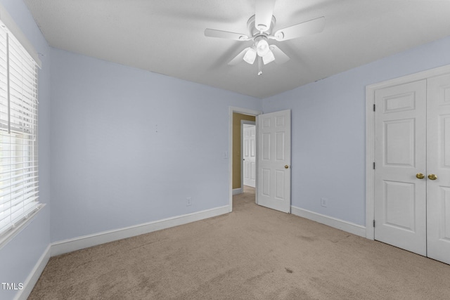 2205 Bufflehead Rd, Raleigh, NC 27616 - unfurnished bedroom featuring carpet flooring, multiple windows, and a closet