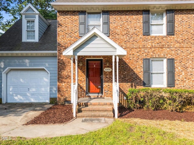 2205 Bufflehead Rd, Raleigh, NC 27616 - view of front of home with an attached garage, brick siding, roof with shingles, and driveway