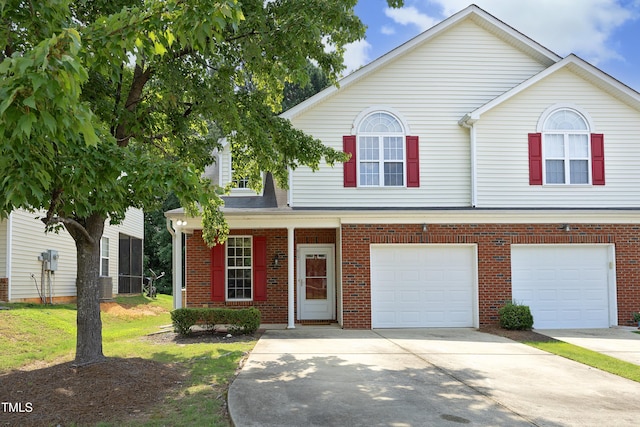 617 Woodson Dr, Clayton, NC 27527 - view of front of home with concrete driveway, an attached garage, and brick siding