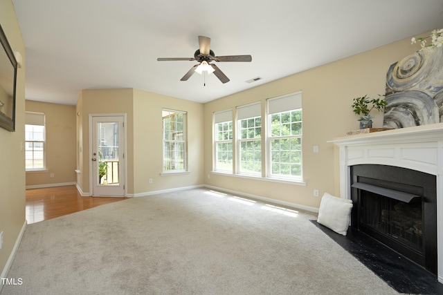 617 Woodson Dr, Clayton, NC 27527 - unfurnished living room with carpet flooring, a fireplace with flush hearth, and a ceiling fan