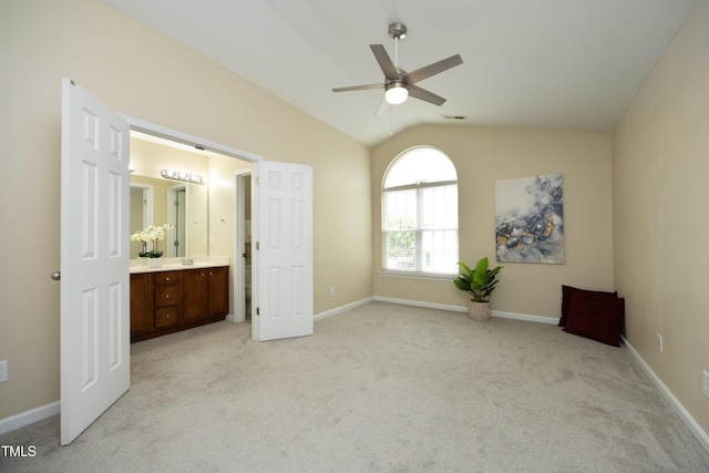 617 Woodson Dr, Clayton, NC 27527 - unfurnished bedroom with light colored carpet, lofted ceiling, ensuite bathroom, and ceiling fan