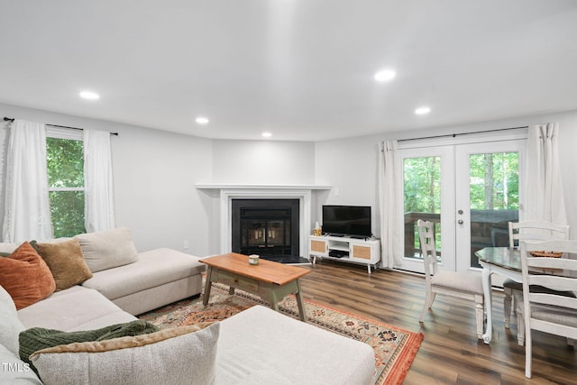 7286 Shellburne Dr, Raleigh, NC 27612 - living area featuring french doors, recessed lighting, wood finished floors, and a fireplace with flush hearth