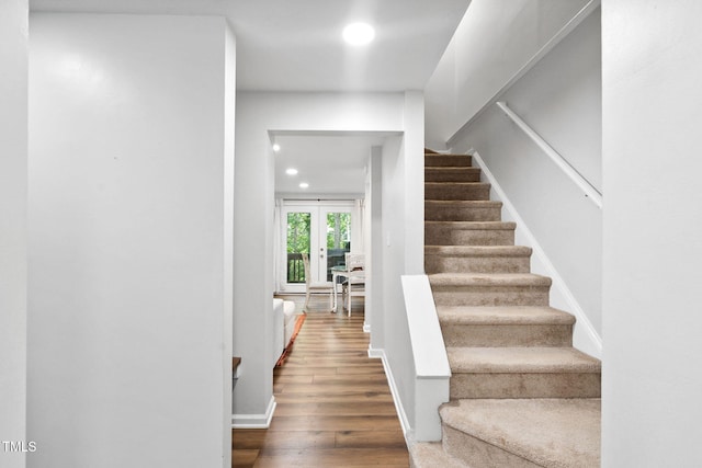 7286 Shellburne Dr, Raleigh, NC 27612 - staircase featuring recessed lighting, french doors, and wood finished floors