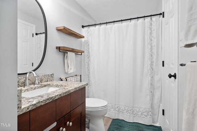 7286 Shellburne Dr, Raleigh, NC 27612 - full bathroom with vanity, wood finished floors, and vaulted ceiling