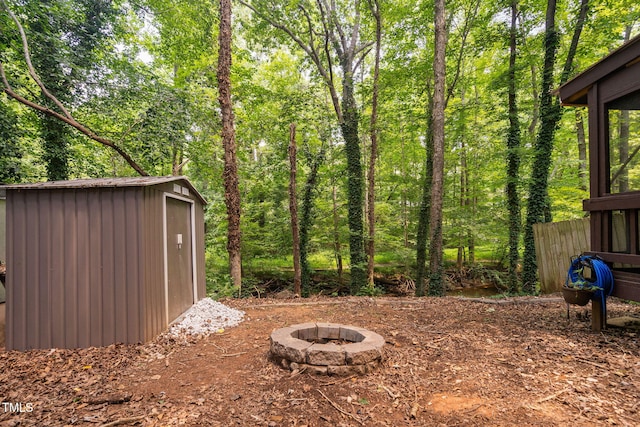 7286 Shellburne Dr, Raleigh, NC 27612 - view of yard with a storage unit and a fire pit