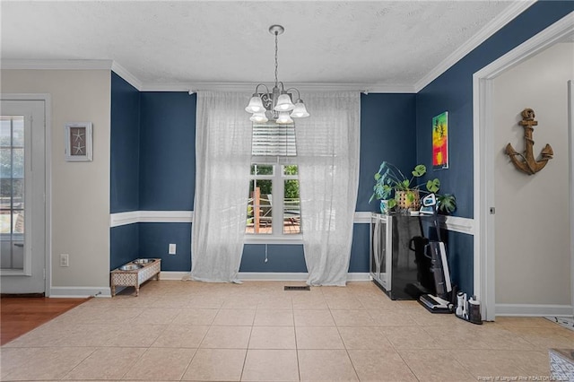 195 Hogart St, Raeford, NC 28376 - tiled dining space featuring a chandelier, plenty of natural light, a textured ceiling, and ornamental molding