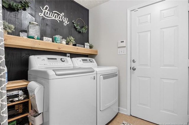 195 Hogart St, Raeford, NC 28376 - laundry area with washing machine and dryer, tile patterned flooring, and a textured ceiling