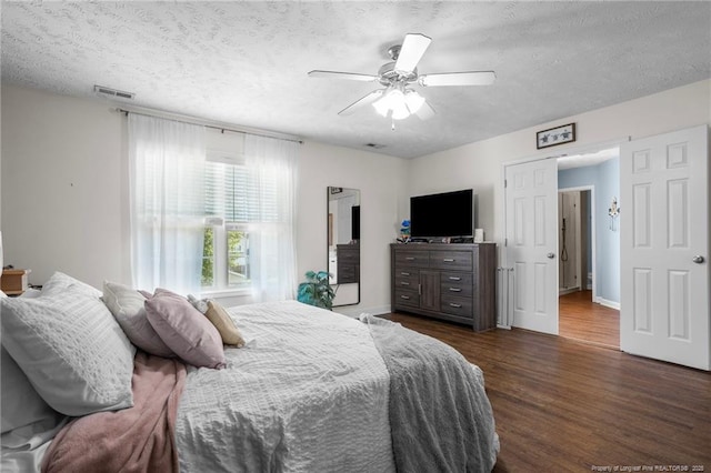 195 Hogart St, Raeford, NC 28376 - bedroom featuring dark wood finished floors, a textured ceiling, and ceiling fan