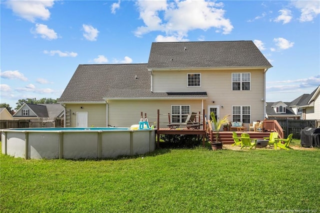 195 Hogart St, Raeford, NC 28376 - back of property featuring a wooden deck and an outdoor pool
