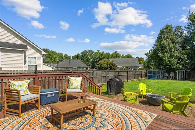 195 Hogart St, Raeford, NC 28376 - wooden deck featuring a grill, a fenced backyard, and a fire pit