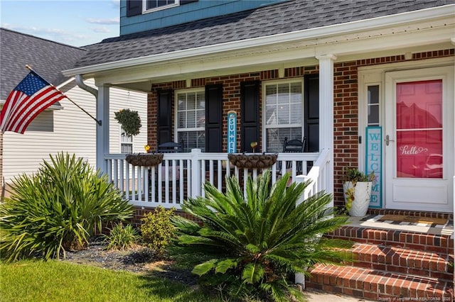 195 Hogart St, Raeford, NC 28376 - entrance to property featuring a shingled roof, covered porch, and brick siding