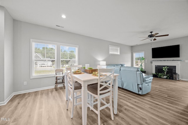 19 Linda Lou Ln Unit 19, Angier, NC 27501 - dining room with light wood-type flooring, a ceiling fan, a fireplace, and recessed lighting