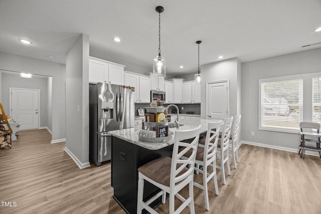 19 Linda Lou Ln Unit 19, Angier, NC 27501 - kitchen with appliances with stainless steel finishes, decorative backsplash, light wood-style flooring, white cabinets, and recessed lighting