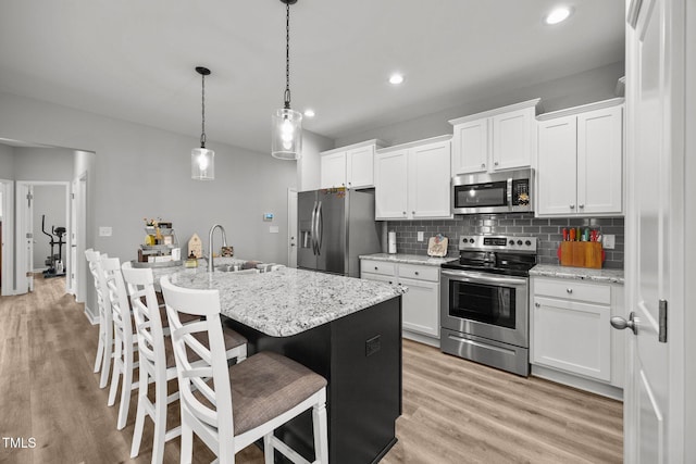 19 Linda Lou Ln Unit 19, Angier, NC 27501 - kitchen featuring appliances with stainless steel finishes, tasteful backsplash, white cabinetry, light wood-style flooring, and recessed lighting