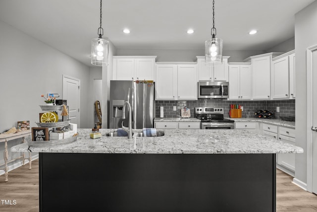 19 Linda Lou Ln Unit 19, Angier, NC 27501 - kitchen with stainless steel appliances, backsplash, a center island with sink, white cabinetry, and recessed lighting