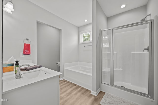 19 Linda Lou Ln Unit 19, Angier, NC 27501 - full bath with wood finished floors, a shower stall, a bath, vanity, and recessed lighting