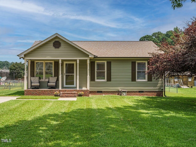 635 Raymond Dr, Wendell, NC 27591 - view of front facade featuring crawl space, a shingled roof, a sunroom, and a playground