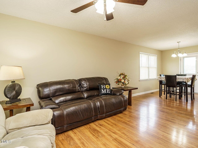 635 Raymond Dr, Wendell, NC 27591 - living room with light wood-type flooring, a chandelier, ceiling fan, and a textured ceiling