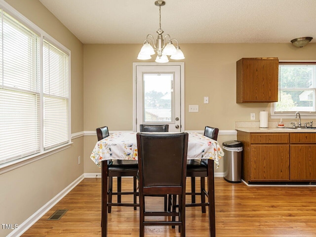 635 Raymond Dr, Wendell, NC 27591 - dining room with light wood-type flooring and a chandelier
