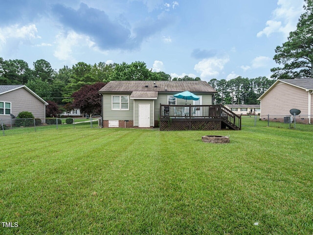 635 Raymond Dr, Wendell, NC 27591 - fenced backyard with a wooden deck and an outdoor fire pit