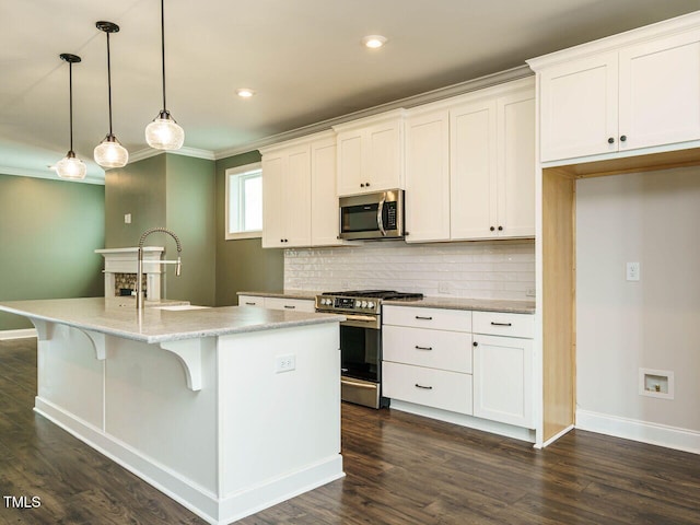 2013 Woodbluff Dr, Wendell, NC 27591 - kitchen with stainless steel appliances, backsplash, an island with sink, white cabinetry, and crown molding