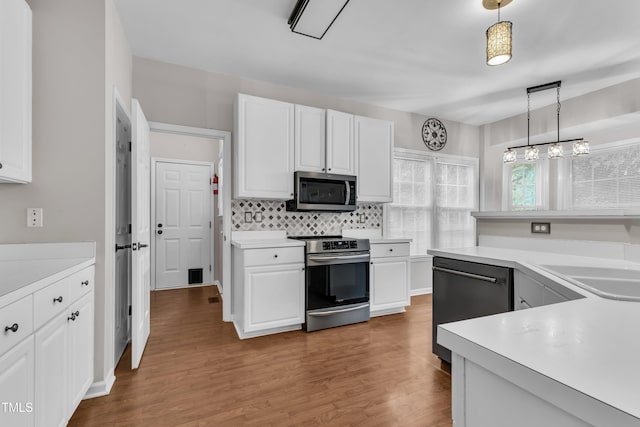 605 Catlin Rd, Cary, NC 27519 - kitchen with appliances with stainless steel finishes, white cabinetry, and light countertops