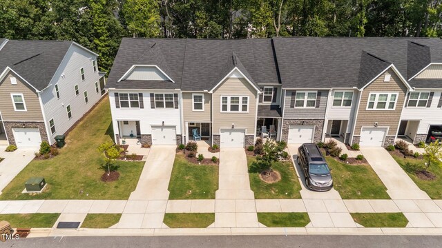 156 Velvet Ridge Way, Garner, NC 27529 - view of property with driveway, stone siding, a shingled roof, and an attached garage