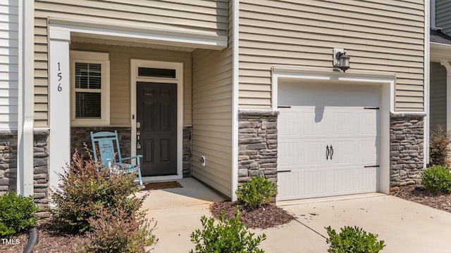 156 Velvet Ridge Way, Garner, NC 27529 - property entrance with stone siding and a garage